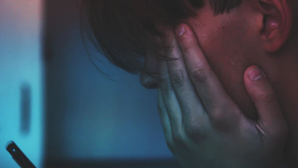 Frustrated man holding his head in his hands