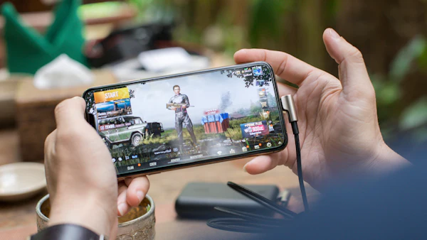 Person playing a game on an Android phone held in landscape mode