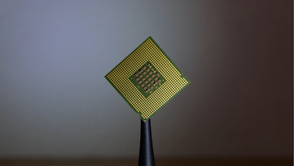 Close-up of a processor chip held by tweezers